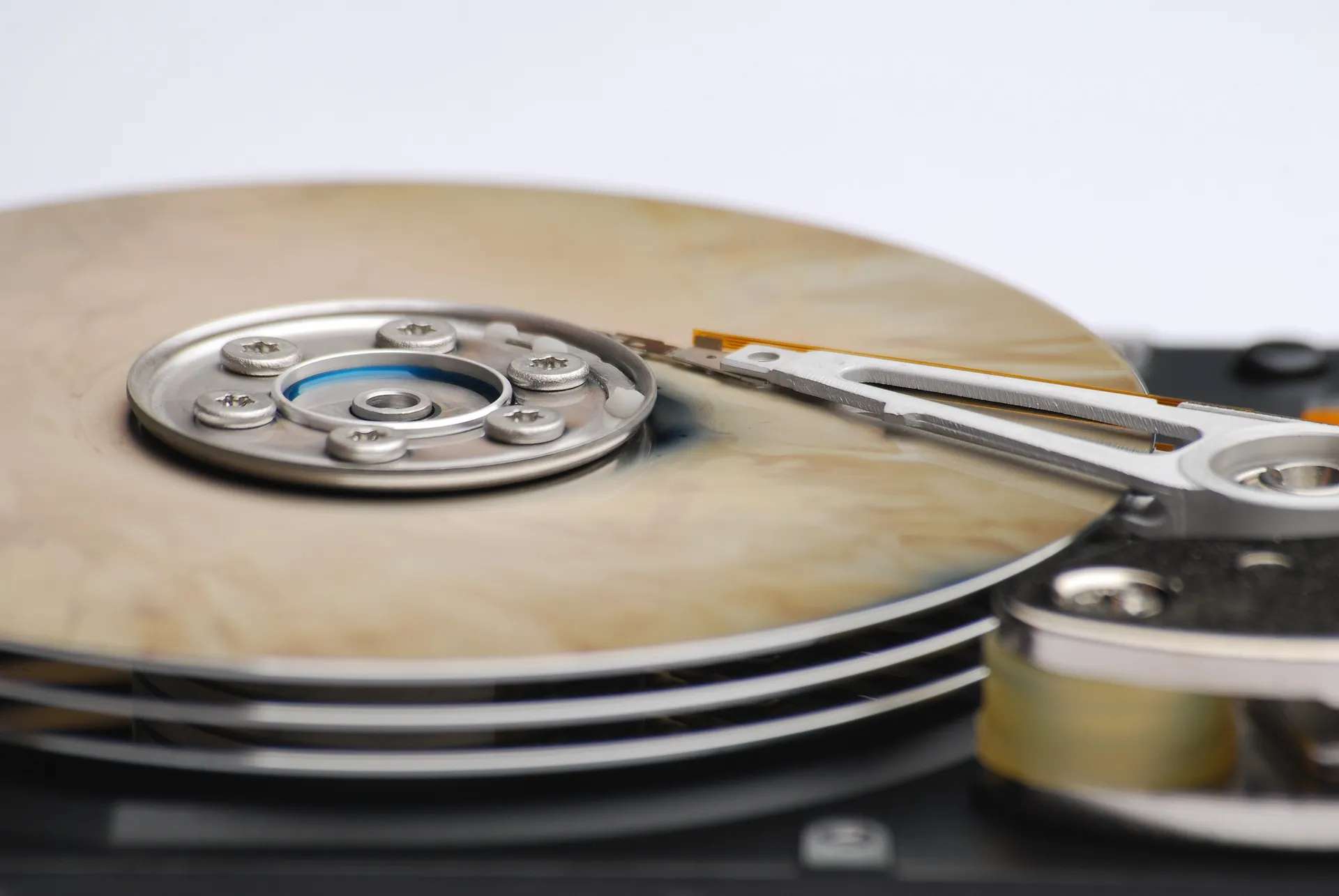 A hard drive held in place by a metal clamp, illustrating its secure setup for effective data management.