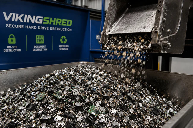 Viking Shred equipment releasing shredded hard drive fragments.