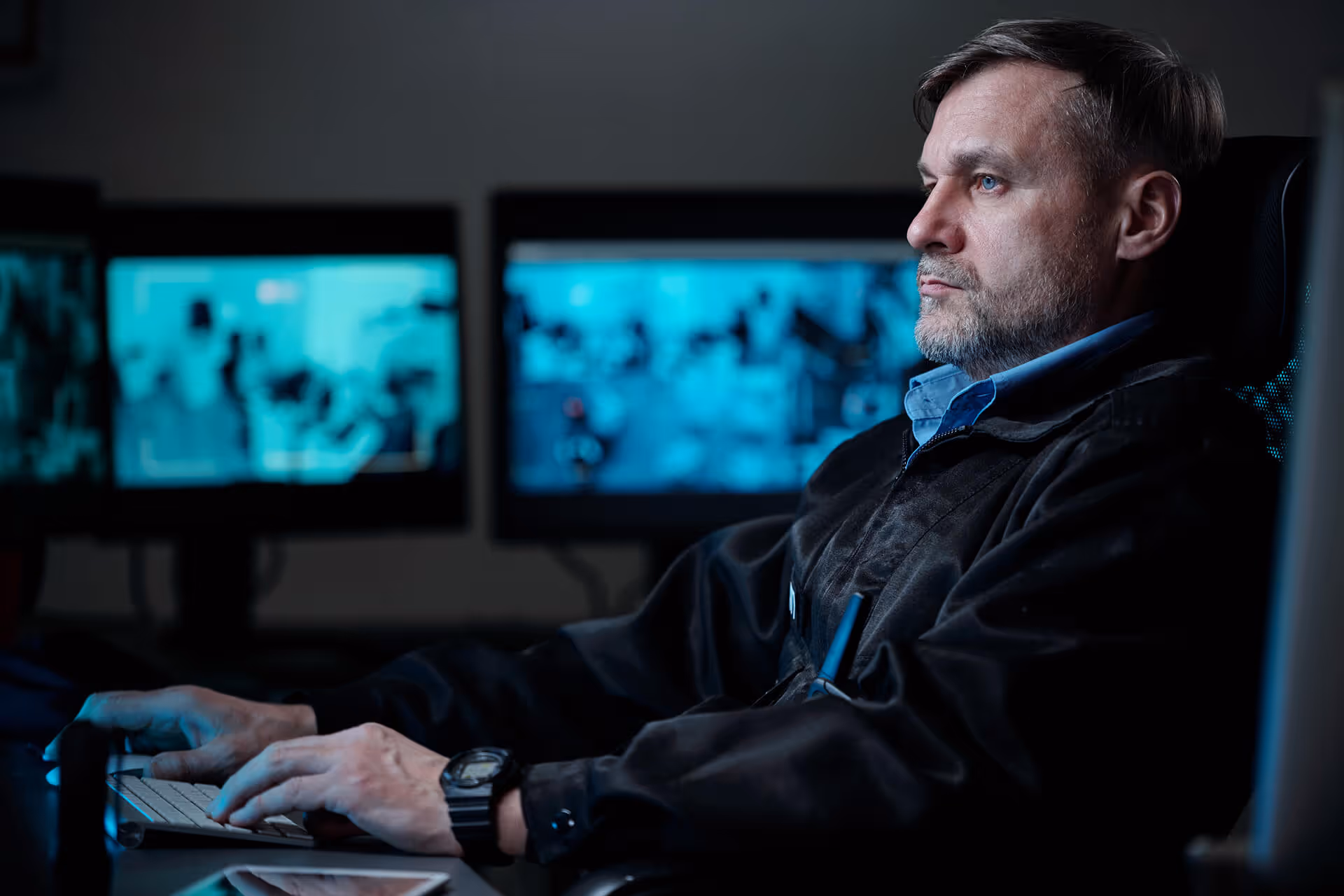 A security guard monitoring surveillance camera feeds.