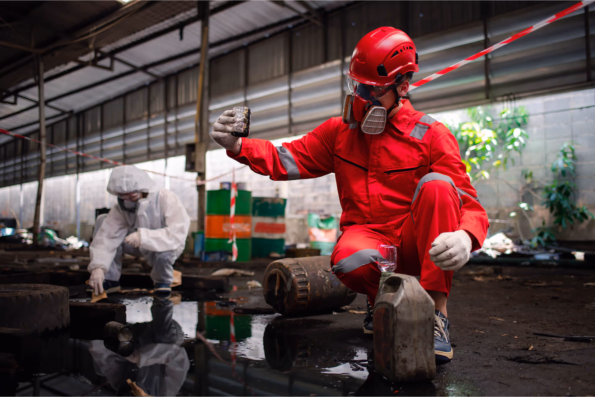 Worker wearing a safety uniform and gas mask.