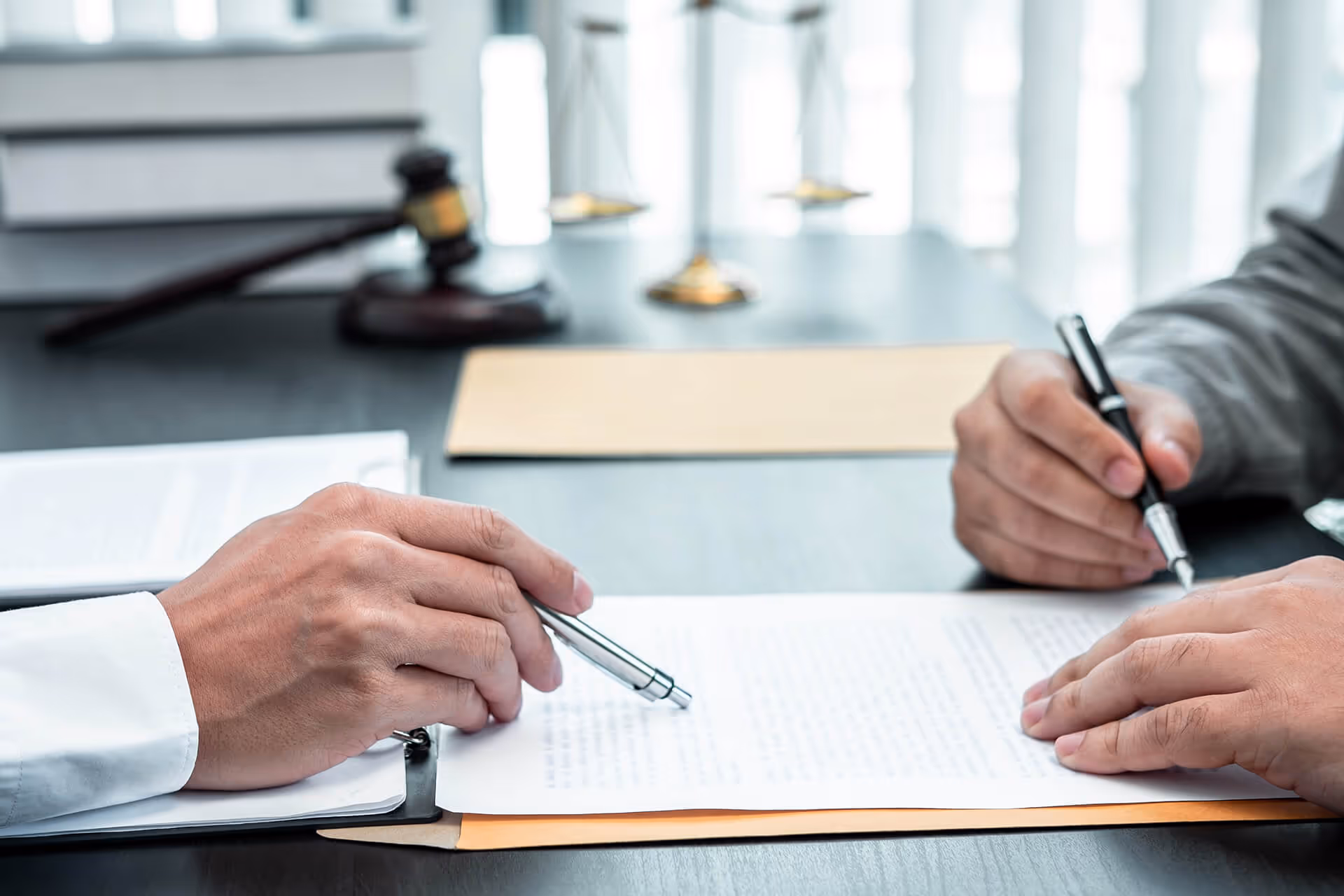 A lawyer discussing a legal document with a client in an office.