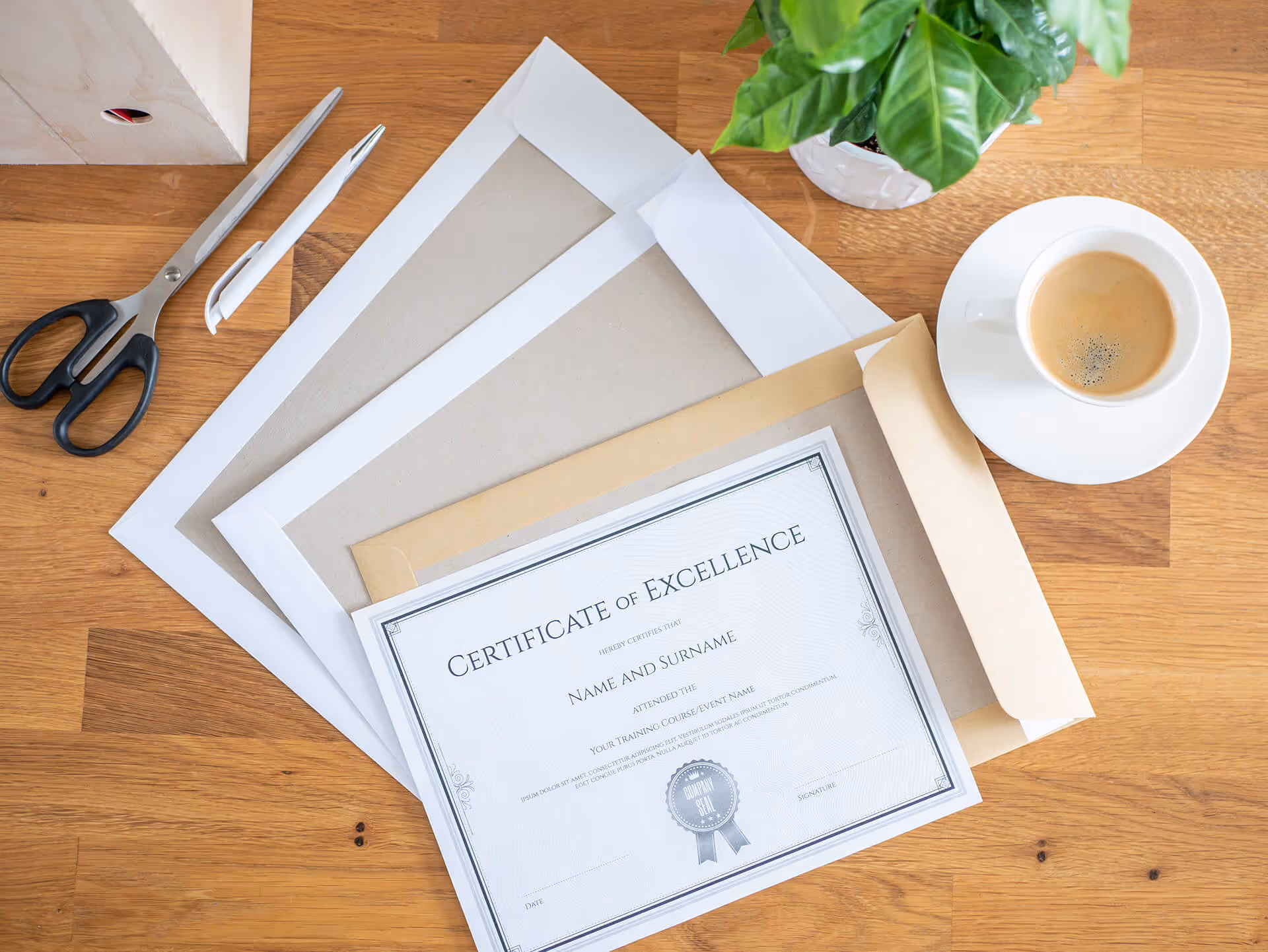 A formal certificate inside a heavy paper envelope on a wooden desk.